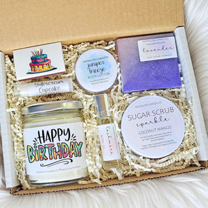 Gift set with candles, soap, and body lotion on a soft surface