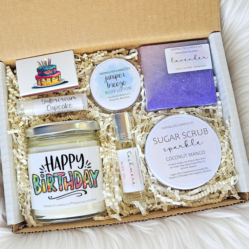 Gift set with candles, soap, and body lotion on a soft surface