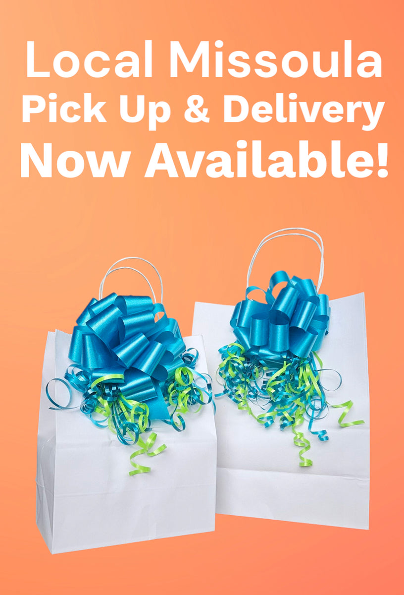 Two gift bags with blue ribbons on an orange background with text about local Missoula Montana gift box pick up and delivery. Flower arrangement alternative