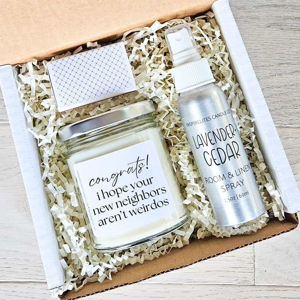 Gift set with candle and room spray in a box on a wooden surface